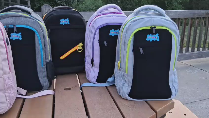 Load video: Video of four backpacks on a wooden table